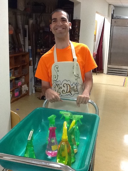 David pushing cart with cleaning supplies.