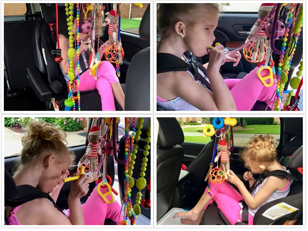Ivey sitting in the car with sensory toys/items in front of her.